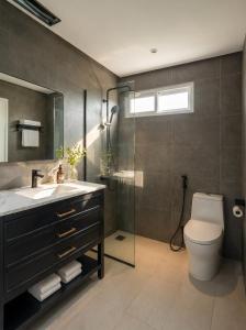 a bathroom with a toilet and a sink and a shower at Soléa Boutique Hotel & Spa By Sol in Ho Chi Minh City