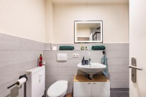 a bathroom with a sink and a toilet at Panorama Suite Quickborn in Quickborn +11 photos