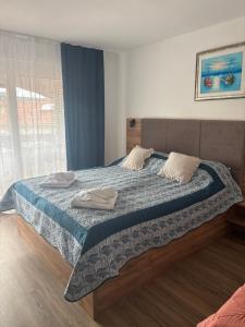 a bedroom with a bed with two towels on it at Apartmani Baja in Lopar