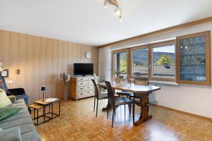 a living room with a table and a couch at Försterhaus Wohnung Obergeschoss in Egg