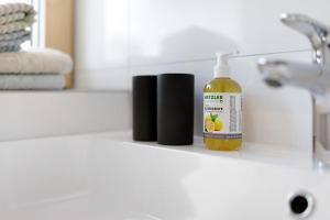 a bottle of liquid soap sitting on a bathroom counter at Försterhaus Wohnung Obergeschoss in Egg +9 photos