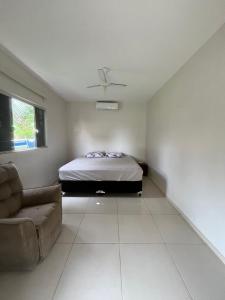 a bedroom with a bed and a couch at Rancho Rocha in Buritama
