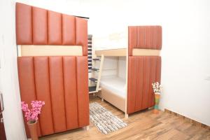 a room with two bunk beds and a closet at Dune Hostel - Dune Homestay in Alleppey
