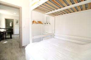 a bedroom with a white bed and a piano at Little Paradise in Castro Marim