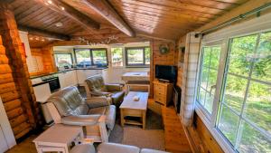 a living room with couches and a kitchen in a tiny house at Lunalodge in Trawsfynydd