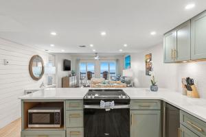 a kitchen with a stove and a counter top at Pinnacle Port, C2-603 in Panama City Beach