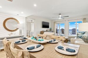 a living room with a table with chairs and a couch at Pinnacle Port, C2-603 in Panama City Beach