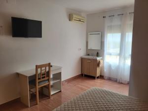a room with a desk and a sink and a mirror at Casa Santa Úrsula in Casinos
