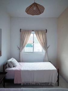 a bedroom with a bed and a window at Casa Tota in Assomada +12 photos