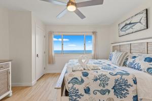 a bedroom with a bed with a view of the ocean at Pinnacle Port, C2-603 in Panama City Beach +28 photos