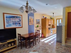 a kitchen and dining room with a table and chairs at Casa di Marie in Mafalda