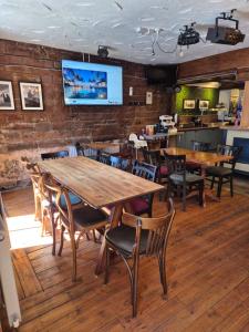 a dining room with wooden tables and chairs at The Old Victoria in Penrith