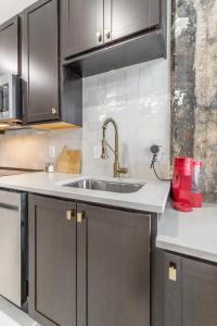a kitchen with a sink and black cabinets at Park Hotel Studio Suite 511 in Chattanooga