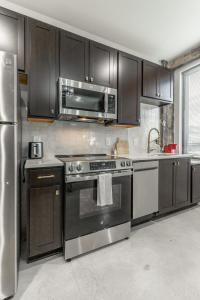 a kitchen with a stainless steel stove and a microwave at Park Hotel Studio Suite 511 in Chattanooga