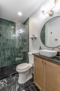 a bathroom with a toilet and a sink and a mirror at Park Hotel Studio Suite 511 in Chattanooga +14 photos