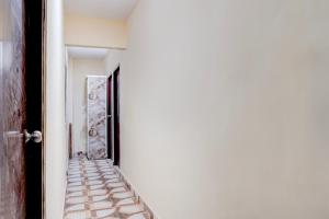 an empty corridor with an open door and a corridorngthngthngthngthngthngth at Hotel O Shivay Inn Ayodhaya Bypass Road in Bhopal