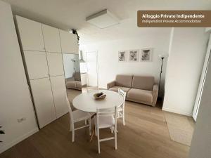 a living room with a white table and a couch at Isola Chiara in Cagliari