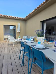 a patio with a table and chairs on a deck at Villas Vangarone in Lecci