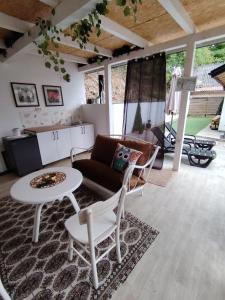 a living room with a couch and a table at Kuća za odmor MERLIN HOUSE in Vrnjačka Banja