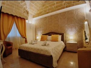 a bedroom with a large bed and a window at B&B I like salento in Uggiano la Chiesa