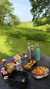 a table with food and other foods on it at yourtes coccinelles in Conchez-de-Béarn