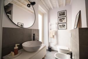 a bathroom with a large bowl sink and a mirror at SaliScendi in Pietrasanta