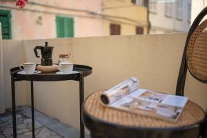 a table with a coffee maker and cups on it at SaliScendi in Pietrasanta