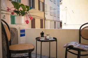 a couple of tables and chairs on a balcony at SaliScendi in Pietrasanta