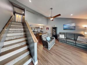 a living room with a staircase and a couch at Kontiki Bayfront Condo #710 in Rockport