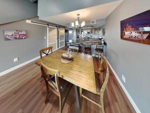a dining room and kitchen with a wooden table and chairs at Kontiki Bayfront Condo #710 in Rockport