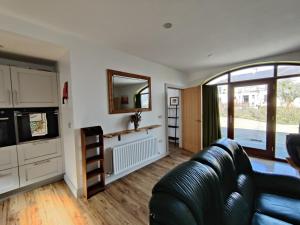 a living room with a couch and a mirror at 50-5 Coolyvenny in Killure