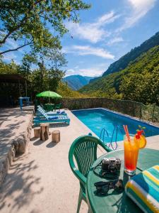 a table with a drink on it next to a swimming pool at Camping Three poplars by VL in Alaverdi