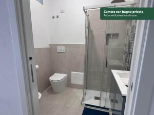 a bathroom with a shower and a toilet and a sink at Isola Chiara in Cagliari