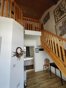 a hallway with a staircase and a living room at 50-5 Coolyvenny in Killure +19 photos