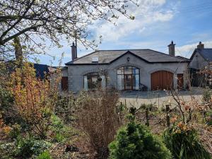 an old house with a garden in front of it at 50-5 Coolyvenny in Killure