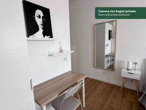 a room with a wooden table and a mirror at Isola Chiara in Cagliari