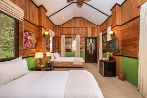 a bedroom with a bed and a television in it at Nawa Wellness in Calatagan +150 photos