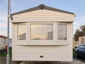 a small house with a window on the side of it at Abi tebay oakfields towyn in Kinmel Bay