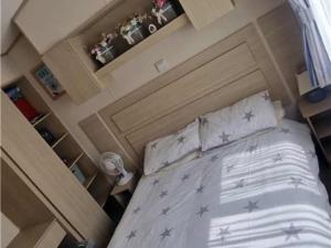 a bedroom with a bed with stars on it at Abi tebay oakfields towyn in Kinmel Bay +1 photo