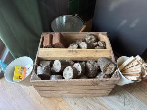 a crate of different types of donuts on a table at Acorn Cabin in Welshpool