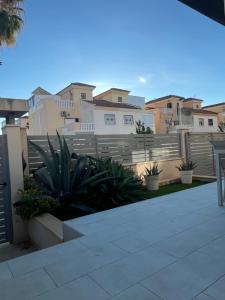 a view of a house with a fence and plants at Casa Laguna Torrevieja in Torrevieja