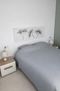 a bedroom with a bed and two pictures on the wall at Casa Laguna Torrevieja in Torrevieja