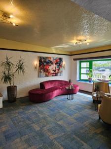 a living room with a red couch in a room at CONTEL Hotel in Koblenz +47 photos