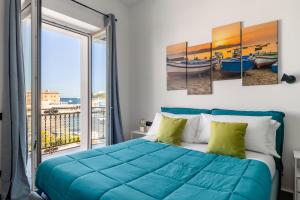 a bedroom with a bed and a balcony at Sant'Erasmo luxury home in Palermo