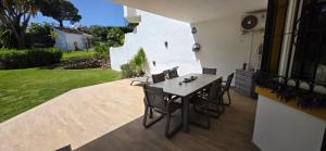 a patio with a table and chairs on a patio at 7 Ocean Point in Sitio de Calahonda