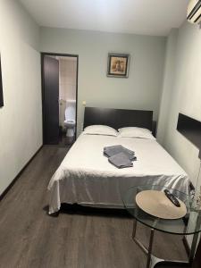 a bedroom with a bed and a table and a toilet at A G Studio's Palas-Iasi 2 in Iaşi +2 photos