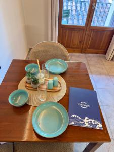 a wooden table with plates and candles on it at Kyriakos Apartments in Politika