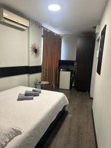 a bedroom with a bed with towels on it at A G Studio's Palas-Iasi 2 in Iaşi