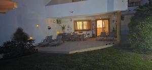 a house with a patio with chairs and a table at 7 Ocean Point in Sitio de Calahonda +40 photos