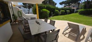 a table with chairs and an umbrella on a patio at 7 Ocean Point in Sitio de Calahonda